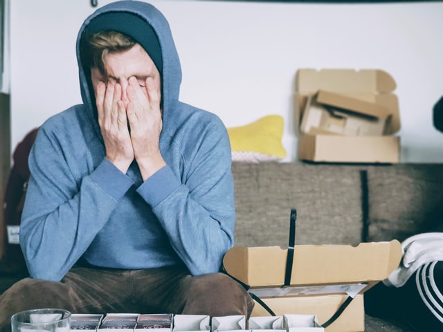 On the image, there is an overwhelmed young man, who has trouble with sensory processing.