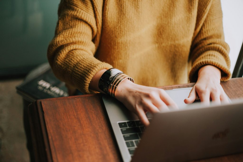 A woman typing on her laptop, representing how various professions can contribute to your personal growth.