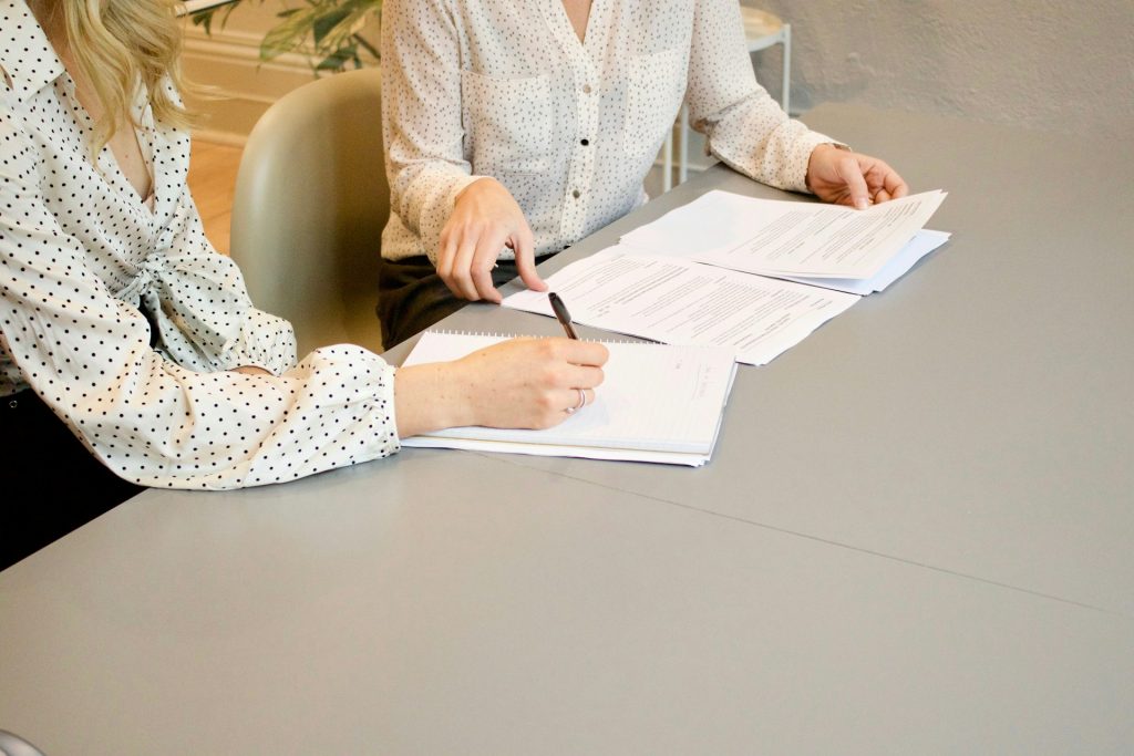 A female lawyer who is communicating with her client, which contributes to her personal growth.