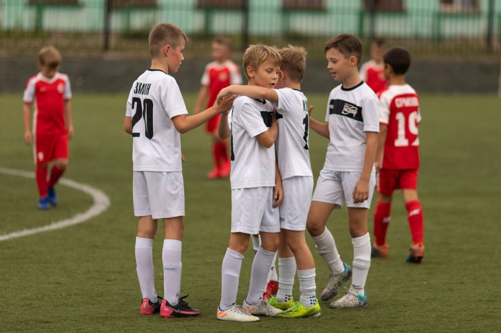 boys on the soccer field wearing white uniforms