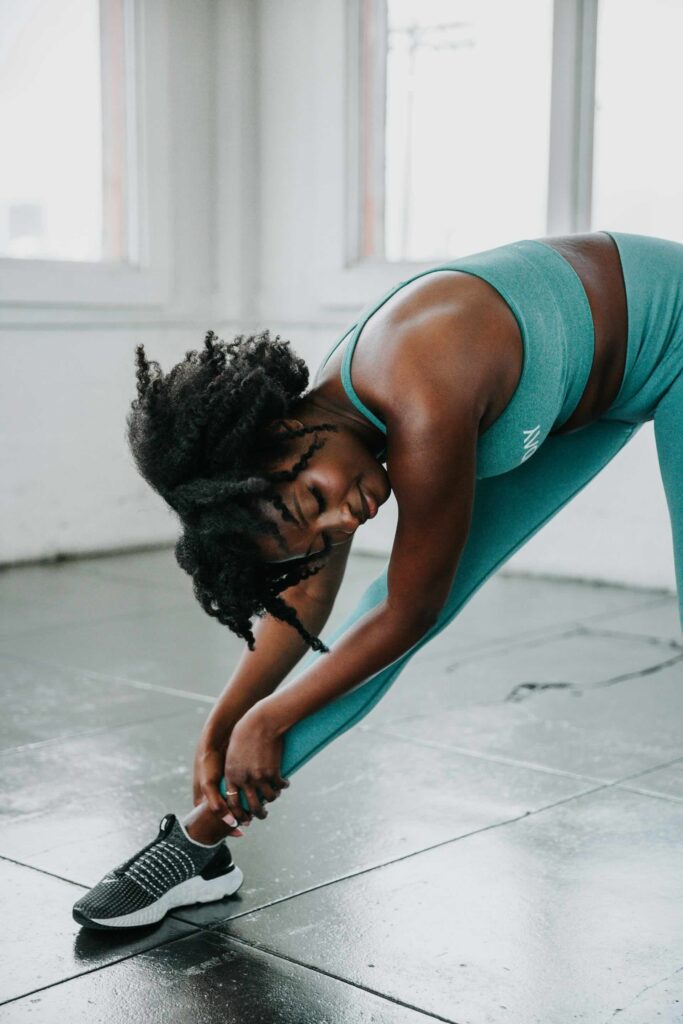 A woman struggling with muscle soreness.